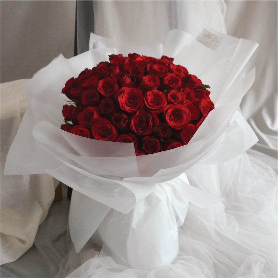 Classic style red roses bouquet with white wrapping paper