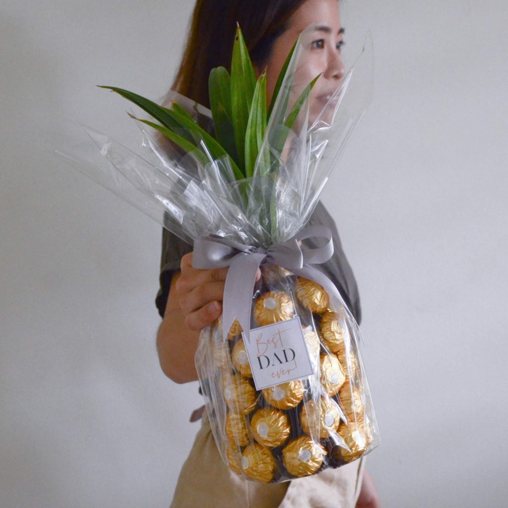 A bottle of Uinah Ginger Beer with Ferrero Rocher chocolates styled in a pineapple shape, Creative gift designed by AfterRainFlorist, PJ Florist