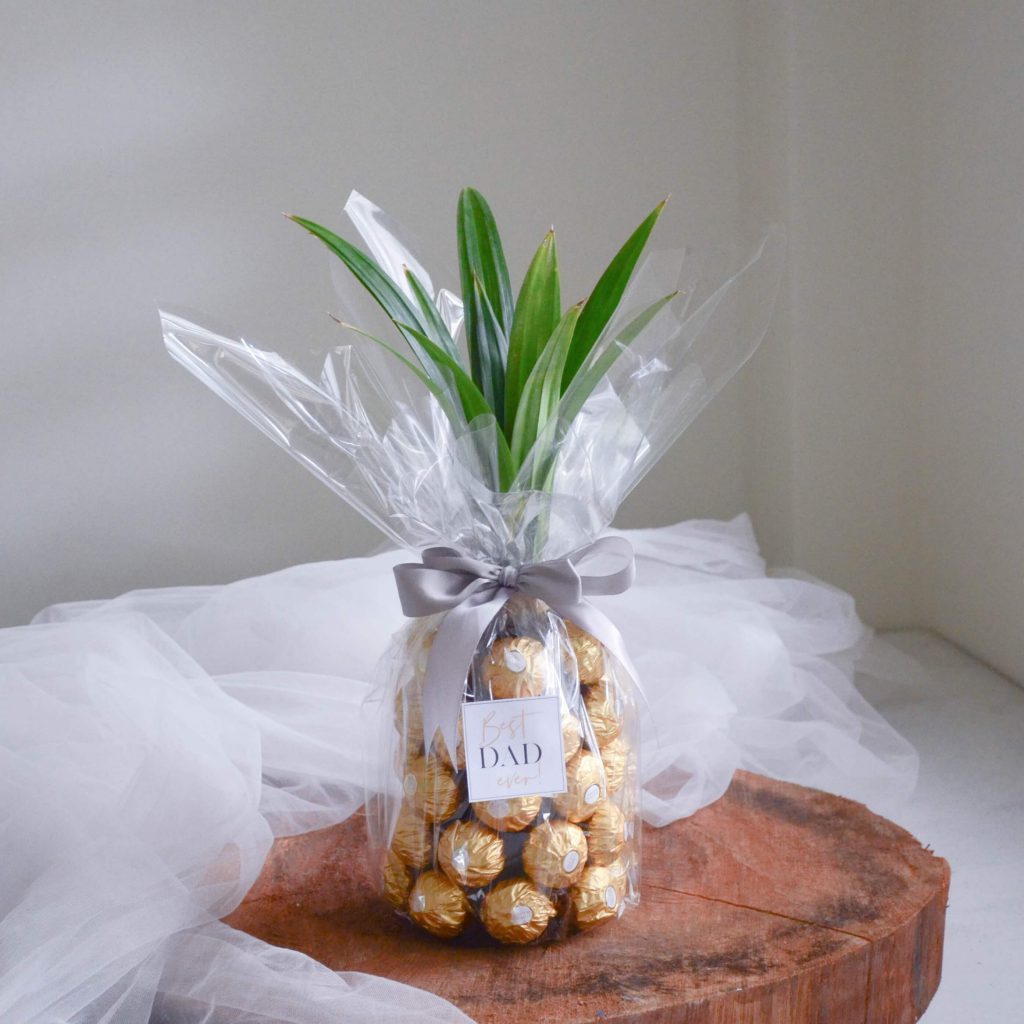 A bottle of Uinah Ginger Beer with Ferrero Rocher chocolates styled in a pineapple shape by AFTERRAINFLORIST
