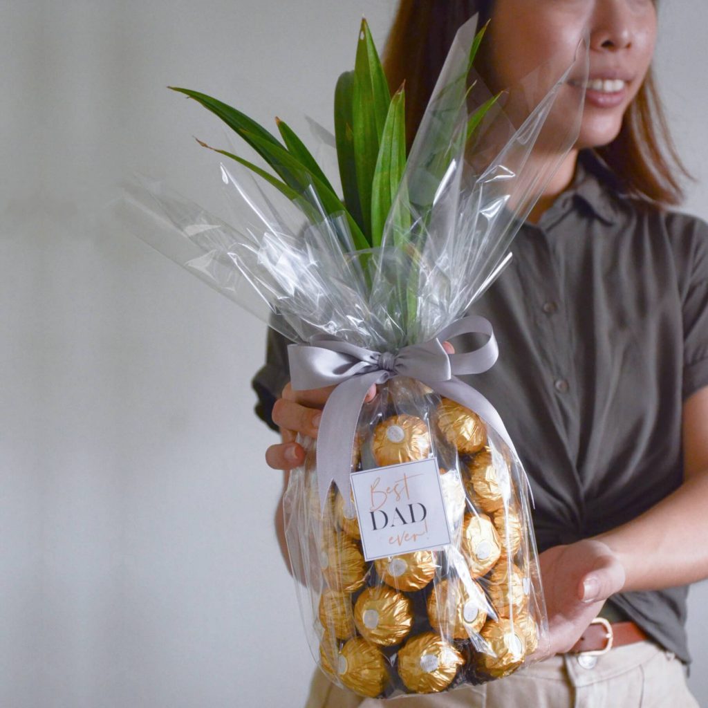 A bottle of Uinah Ginger Beer with Ferrero Rocher chocolates styled in a pineapple shape, Creative gift designed by AfterRainFlorist, PJ Florist